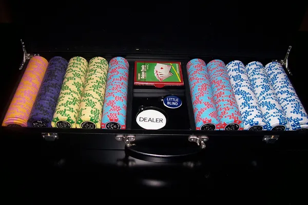 Koffer mit Pokerchips und Dealer-Button